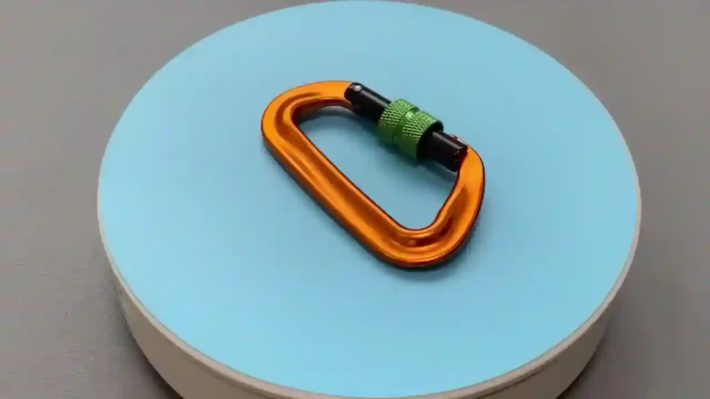 D702S2 orange aluminum locking carabiner with green screw gate for secure gear attachment and outdoor utility.